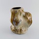 Christina Muff, Danish contemporary ceramicist (b. 1971). Sculptural unique vase 
in glazed stoneware. Beautiful ocher-colored celadon glaze.
