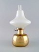 Henning Koppel (1918-81) for Louis Poulsen. "Petronella" oil lamp in brass with 
opaline glass shade.
