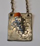 Pewter pendant with amber, 1970s. Denmark. With chain. Unsigned. 6 x 5 cm. Chain length: 67 cm.