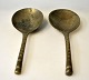 A pair of Asian bronze spoons, 19th century. Shaft with decorations. Length: 22 cm.NB: Sold ...