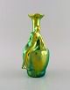 Zsolnay art nouveau vase in glazed ceramics modeled with sitting woman.  
Beautiful luster glaze. 20th century.
