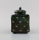 Wilhelm Kåge (1889-1960) for Gustavsberg. Rare Argenta art deco tea caddy in 
glazed ceramics. Beautiful glaze in dark green shades with silver inlay in the 
form of leaves. 1930s.
