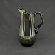 The jug is mouth blown and with an attached handle. It has a so-called ring foot and ...