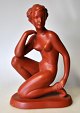 Austrian artist 
20th century - 
presumably 
Gmunder 
Keramik: 
Sitting naked 
woman. Painted 
reds. ...