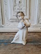 Lladro figure in the form of angel child playing fluteHeight 16 cm.
