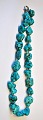 Turquoise 
necklace with 
polished 
pieces, 20th 
century Length: 
46 cm.