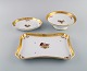 Three Royal Copenhagen Golden Basket dishes in porcelain with flowers and gold 
decoration. Early 20th century.
