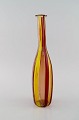 Murano bottle / vase in mouth blown art glass. Polychrome striped design in warm shades. ...