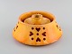 Kähler, 
Denmark. 
Candlestick 
with heater in 
glazed 
stoneware. 
Beautiful 
orange uranium 
glaze. ...