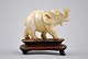 Elephant in ivory on foot of wood, Siam approx.1950 to 1960.L .: 8 cm. H: 8 cm.NB: One tusk ...