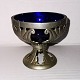 Mogens Ballin´s 
successor: 
Openwork tin 
bowl with art 
nouveau work 
decorations. In 
it blue glass 
...