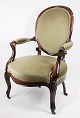 A neo-rococo armchair in mahogany with brand green velor upholstery from around the 1880s. In ...