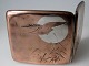 Japanese cigarette case of silver, about 1920. Outside coppered with decorations in the shape of ...