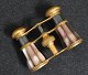 Theater 
binoculars in 
brass and 
mother of 
pearl, ca.1900. 
B: 8.5 cm. H: 7 
cm. Nice 
condition.