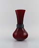 Salviati, Murano. Vase in red mouth blown art glass with matt black ribbon. 
Italian design. Early 21st century.
