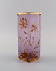 Daum Nancy, France. Art nouveau vase in pink mouth-blown art glass with hand-painted flowers and gold decoration. Early 20th century.