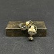 Height 4 cm.The brooch is in golden metal and inlaid enamel in black and silver.It is with ...