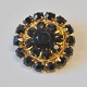 Garnet brooch, 
gilded, 20th 
century. Round 
with 24 cut 
grenades. Dia 
.: 2.8 cm.