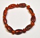 Amber bracelet 
with 18 
polished 
pieces, 
Denmark. Fitted 
with elastic. 
Length 18 cm.