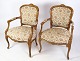 A pair of 
neo-rococo 
armchairs with 
decorated 
fabric in light 
wood from 
around the year 
...