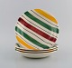 Longchamp, France. Four deep plates in glazed faience with hand-painted striped 
decoration. Mid-20th century.

