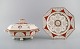 Mintons, England. Antique Holland lidded tureen and plate in hand-painted 
porcelain. Classicist decoration and gold edge. Late 20th century.
