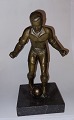 Figure of 
football player 
in bronze. 
Standing on 
stone base. 
Appears in good 
condition. ...