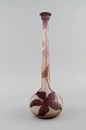 Narrow neck 
Emile Gallé 
vase in frosted 
and purple art 
glass carved in 
the form of 
foliage. ...