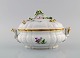 Meissen porcelain lidded tureen with hand-painted flowers and gold edge. Lid 
modeled with flowers and foliage. 1920s.
