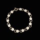 Bernhard Hertz. 
Gilded Sterling 
Silver Daisy 
Bracelet with 
White Enamel. 
7mm
Crafted by ...