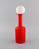 Otto Brauer for 
Holmegaard. 
Vase / bottle 
in red 
mouth-blown art 
glass with 
white ball. ...