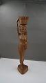 Large and 
beautiful teak 
wood figurine 
of young woman 
with basket on 
head, standing 
on 3-sided ...