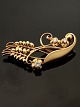 GEORG JENSEN 
vintage 18 
carat gold 
brooch design 
#35 with 3 
brilliant cut 
diamonds 4.3 x 
2 cm. ...