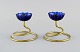 Gunnar Ander 
for Ystad 
Metall. Two 
candlesticks in 
brass and blue 
art glass 
shaped like 
flowers. ...