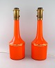 Anders Pehrson for Ateljé Lyktan. Two large table lamps in orange mouth-blown art glass with ...