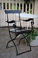 Old French garden chair with armrests in iron with wooden slats, black painted. Can be folded. ...