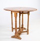 Bright folding 
table in oak 
wood from 
around the 
1890s.
Measurements 
in cm: H:62.5 
W:75 D:60
