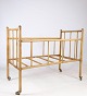 Antique cot in light pine with wheels from around the 1920s.Dimensions in cm: H:75 W:96 D:50