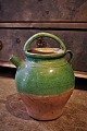 Old pottery jars with pouring spouts from the South of France in green glaze with a fine patina. ...