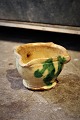 Old pottery dish from the South of France in ocher / green glaze with a fine patina. The ...