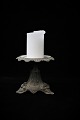 Old French block candlestick in dark patinated metal with fine details.H:14cm. Dia:15,5cm.