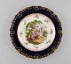 Antique Meissen plate in hand-painted porcelain. Romantic scene, blue border 
with gold decoration. Late 19th century.
