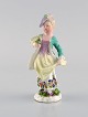 Meissen, Germany. Antique hand-painted porcelain figure. Lady with flowers. Late 19th ...