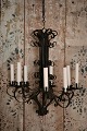 Old raw French metal chandelier with a super patina and with room for 8 candles. The ...