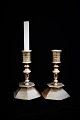 A pair of 1700 century candlesticks in solid brass with fine patina. Height:19,5 cm. Foot, 6 ...