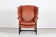 Chesterfield Large wingback chairupholstred with caramel brown leather, brass nails and ...