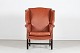 Chesterfield 
Large wingback 
chair
upholstred 
with caramel 
brown leather, 
brass nails 
and ...