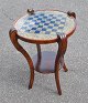 Chessboard - Art Nouveau. ca. 1900. Denmark. Polished beech wood with four legs with cuts. ...