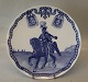 Royal Danish 
husar in 
landscape. 
Round the edge 
a garland with 
two cartridge 
pouches 
carrying ...