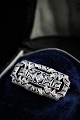 Very beautiful old brooch in 18 carat white gold with 8 small diamonds and a larger diamond in ...